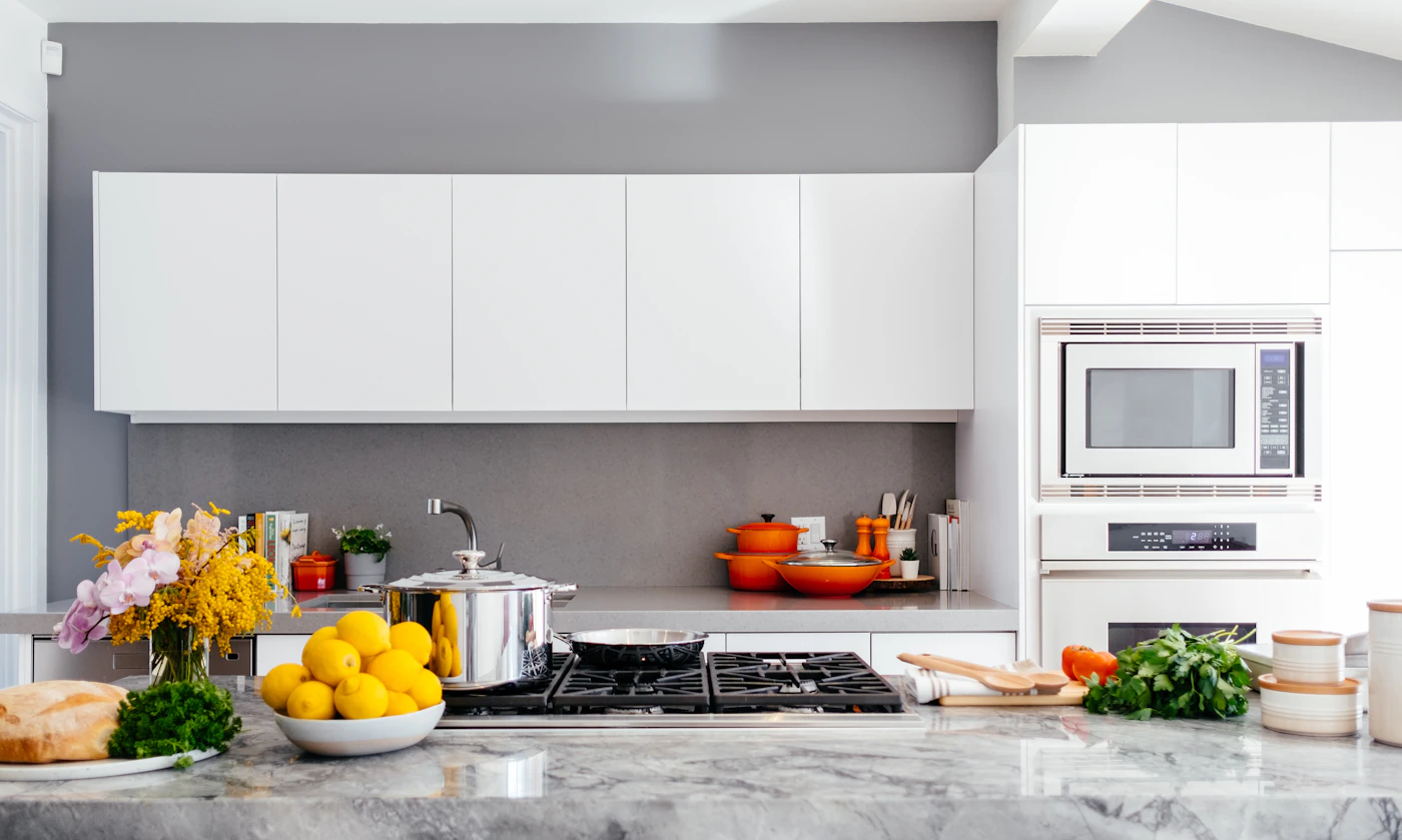 Bright kitchen counter with cookware and fresh produce