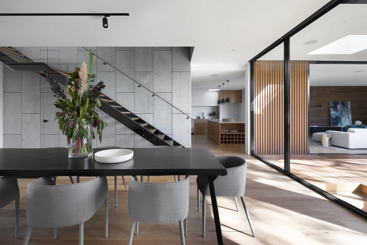 Open entrance and dining area with a staircase and natural light
